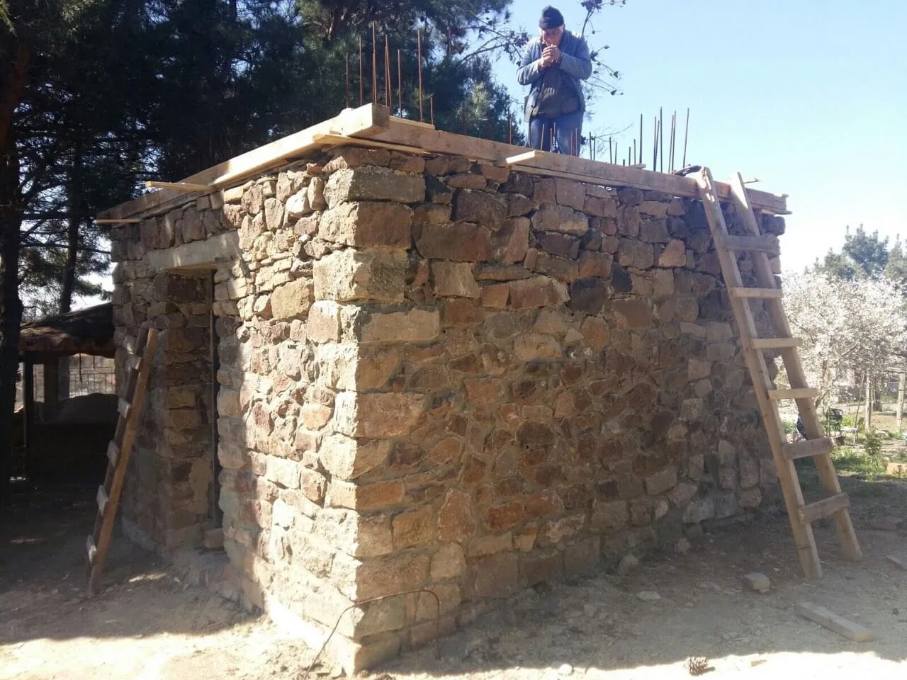 Small outbuilding built with rubble stone masonry under construction
