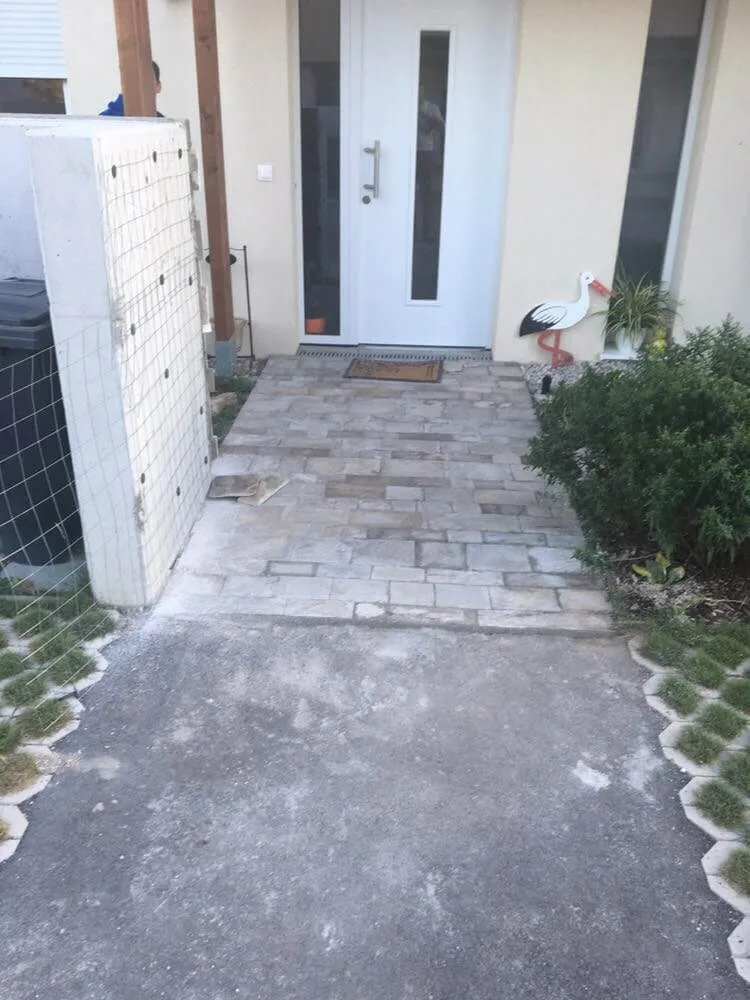 Front entrance pathway paved with rectangular cut stone tiles