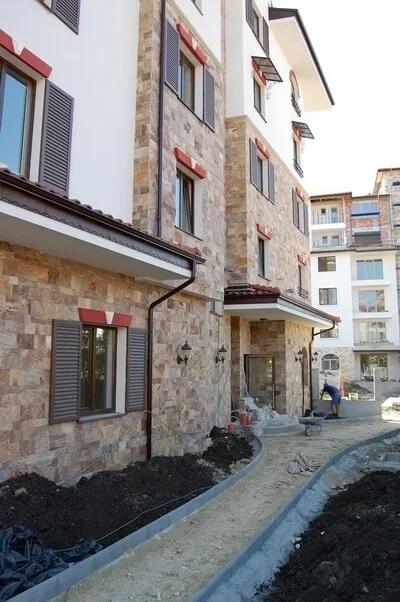 Apartment building facade clad with natural gneiss stone