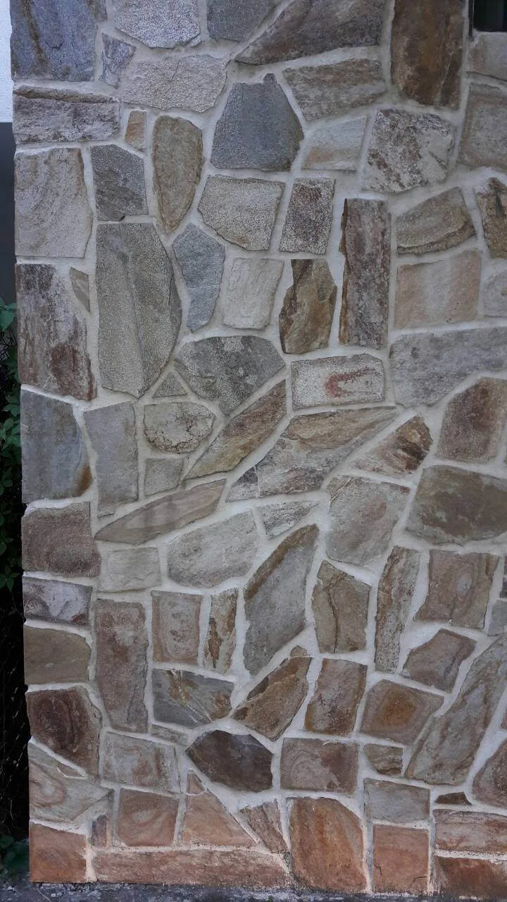 Wall clad with irregular gneiss flagstones and light mortar joints