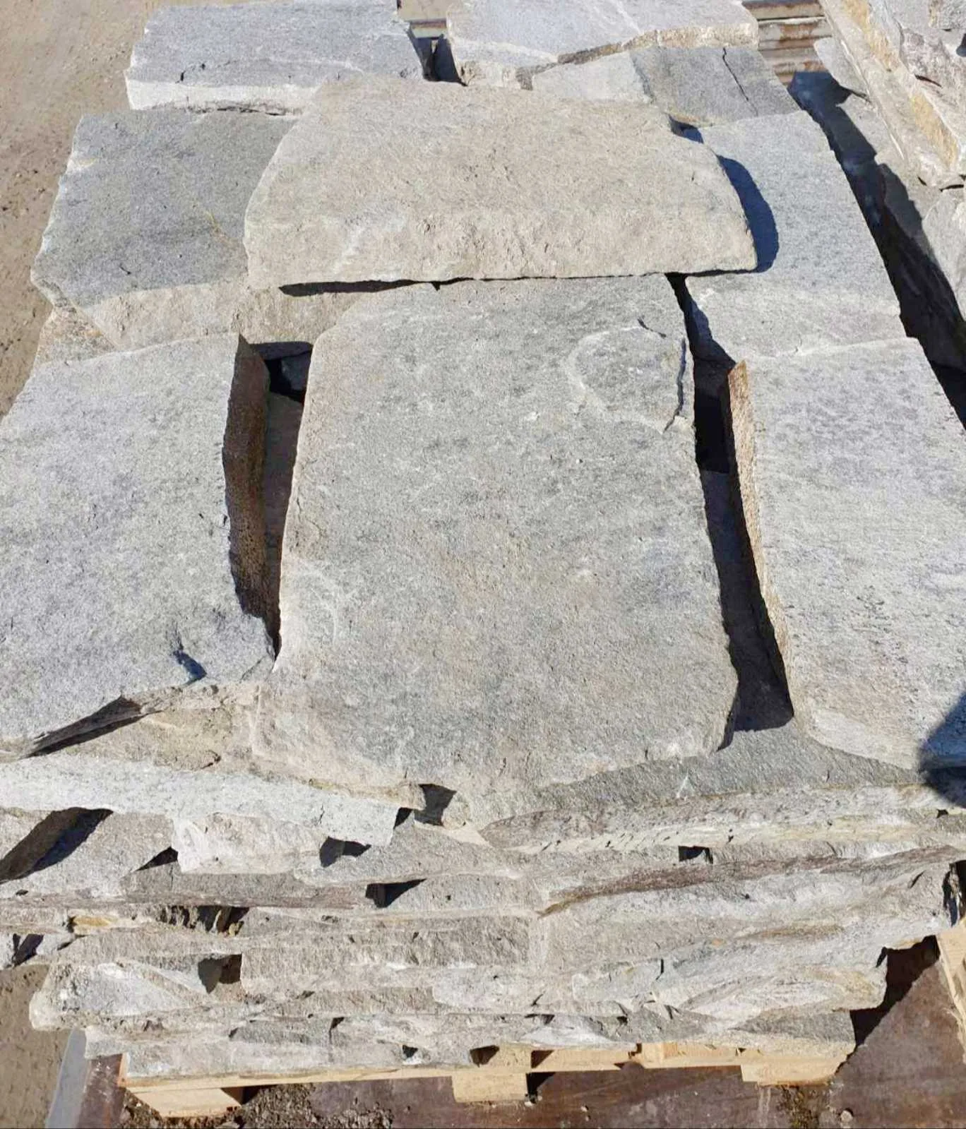 Pallet of irregular gneiss flagstones stacked at the production yard