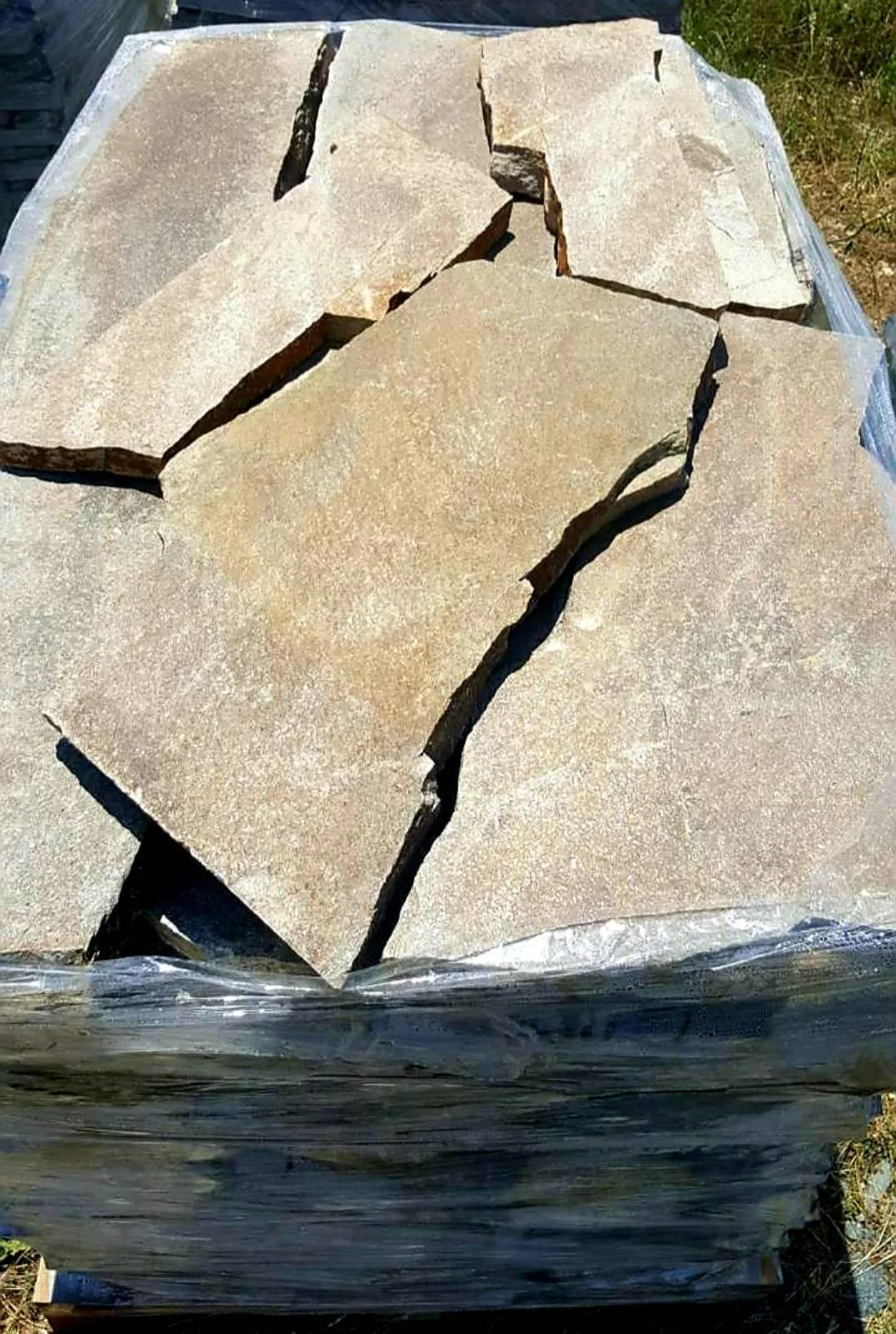Pallet of large beige irregular gneiss flagstones