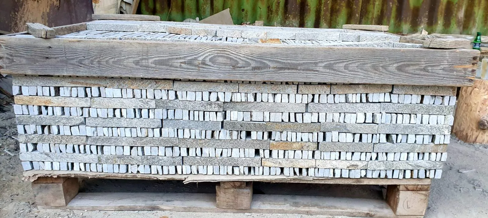 Crate stacked with thin cut gneiss strips at the warehouse