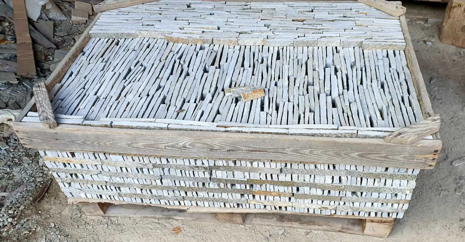 Pallet loaded with narrow gneiss strips for wall cladding