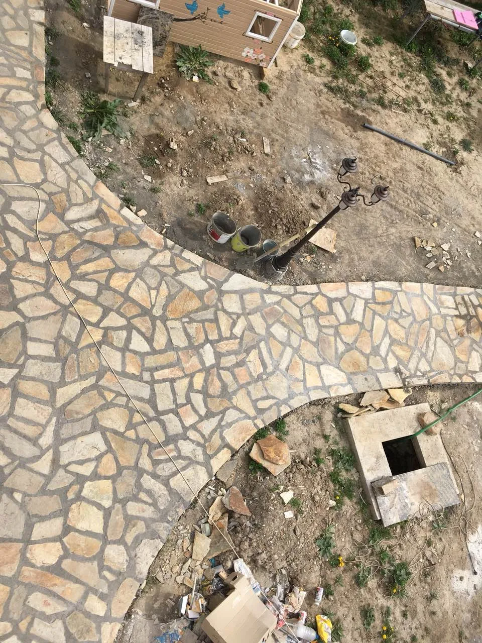 Aerial view of a winding pathway paved with irregular gneiss flagstones